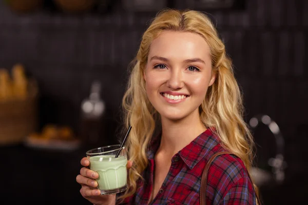 Smiling blonde drinking beverage — Stock Photo, Image