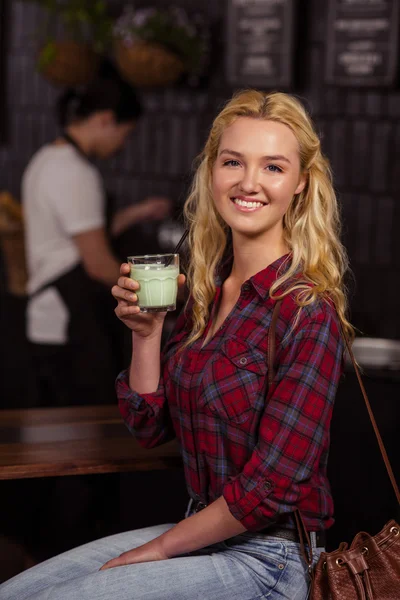 Smiling blonde drinking beverage — Stock Photo, Image