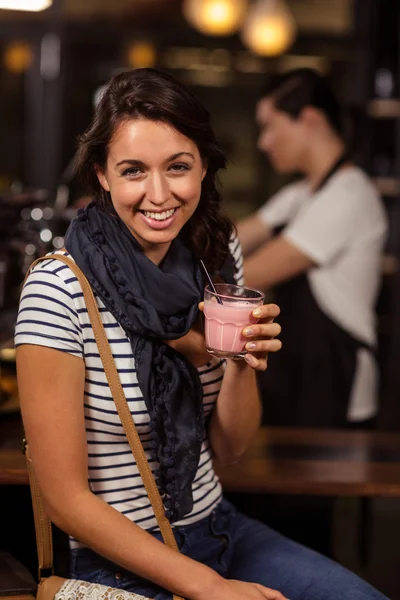 Smiling brunette drinking beverage — Stock Photo, Image