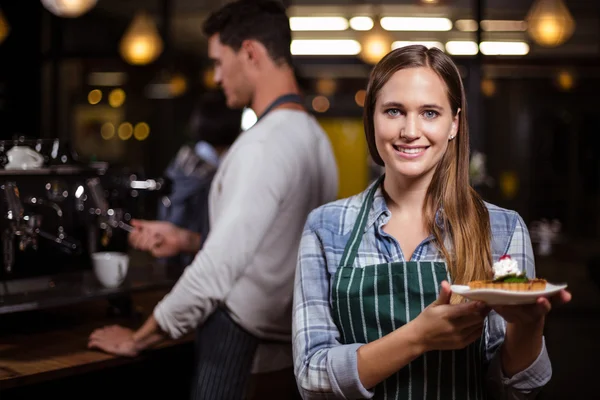 Bonito barista segurando sobremesa — Fotografia de Stock