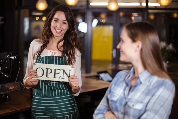 Pretty barista holding open sign — Stock Photo, Image