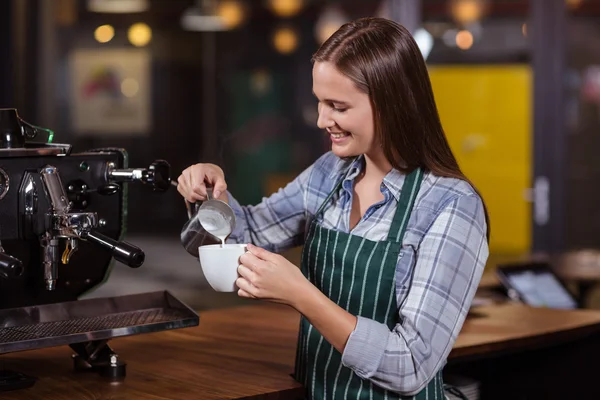 Lachende barista voorbereiding cappuccino — Stockfoto