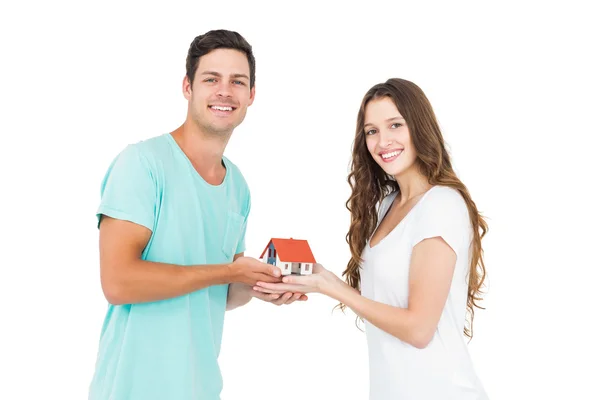 Couple holding miniature house — Stock Photo, Image