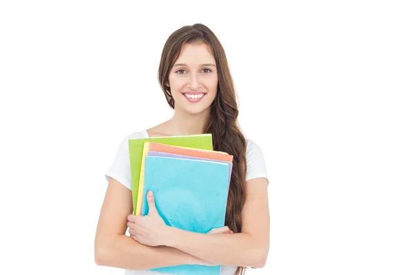 Smiling female college student holding books — Stock Photo, Image