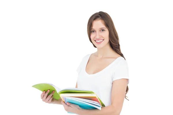 Estudante universitária feliz segurando livros — Fotografia de Stock