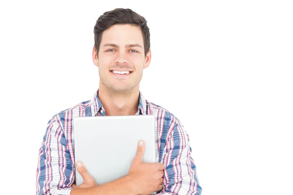 Bir dizüstü bilgisayar tutan gülümseyen erkek öğrenci portresi — Stok fotoğraf