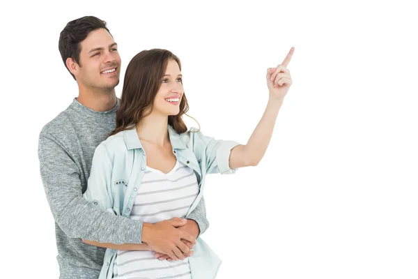 Couple embracing and pointing up — Stock Photo, Image