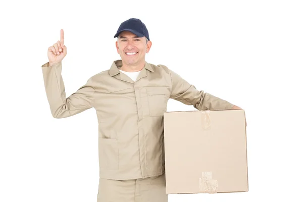 Delivery man carrying a package and pointing — Stock Photo, Image