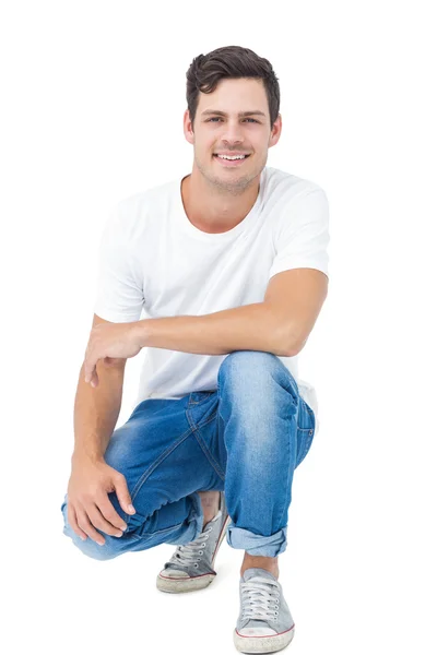 Handsome man crouching — Stock Photo, Image