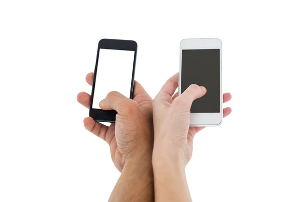 Couple holding smartphones — Stock Photo, Image