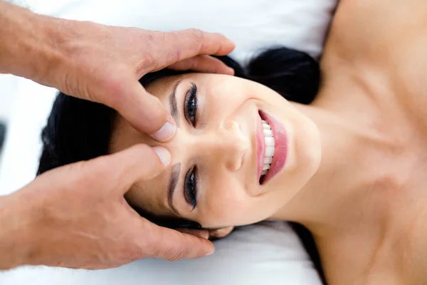 Pregnant woman receiving a head massage from masseur — Stock Photo, Image