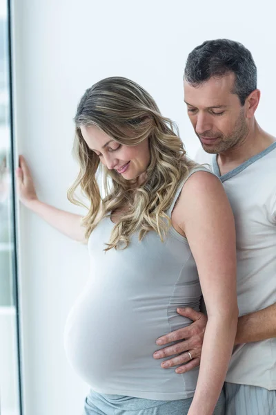 Hombre sosteniendo mujeres embarazadas estómago —  Fotos de Stock