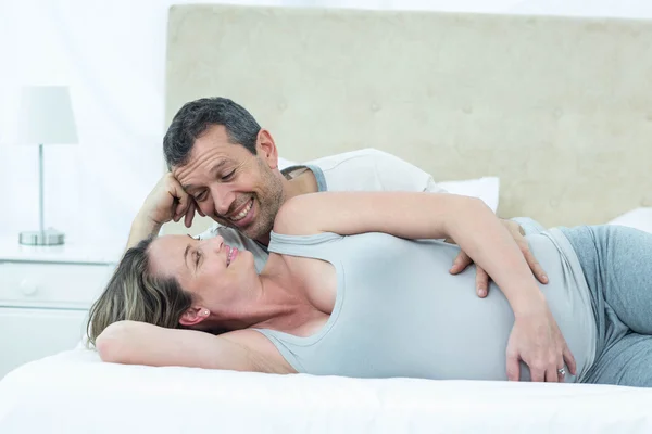 Esperando casal deitado na cama e conversando — Fotografia de Stock