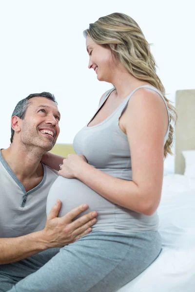 Verwacht paar liggend op bed en chatten — Stockfoto