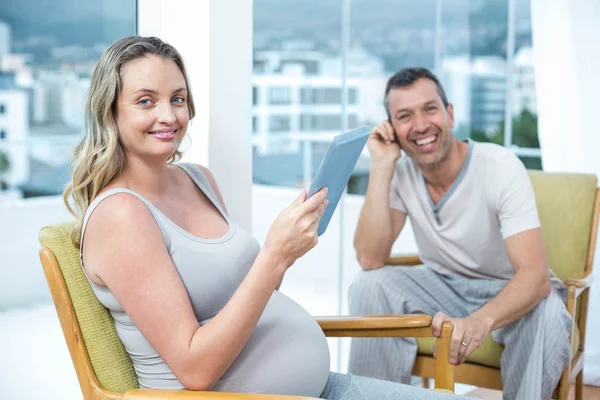 Expecting couple sitting on chair — Stock Photo, Image