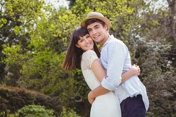 Young couple cuddling outdoors — Stock Photo, Image