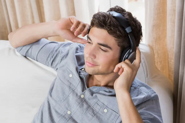 Young man at home relaxing on the sofa — Stock Photo, Image