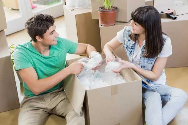 Casal jovem desempacotar caixas de papelão em sua nova casa — Fotografia de Stock