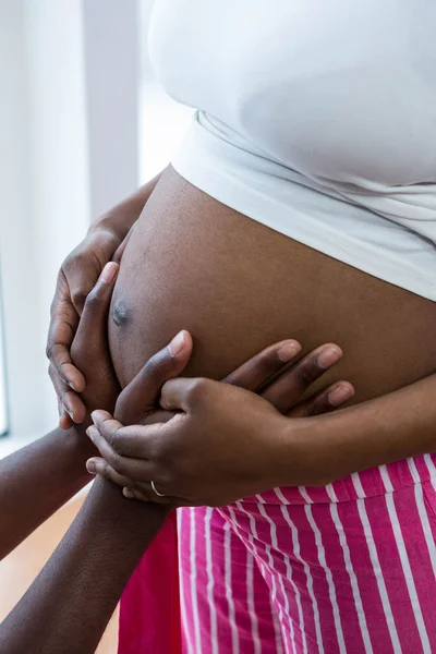 Чоловік торкається вагітної жінки живота — стокове фото