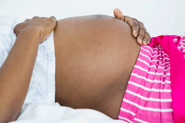 Mid section of woman touching her belly — Stock Photo, Image