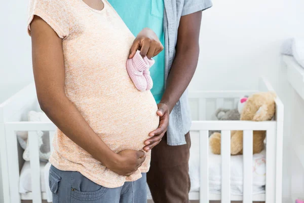 Pembe Bebek Patiği tutan hamile Çift — Stok fotoğraf
