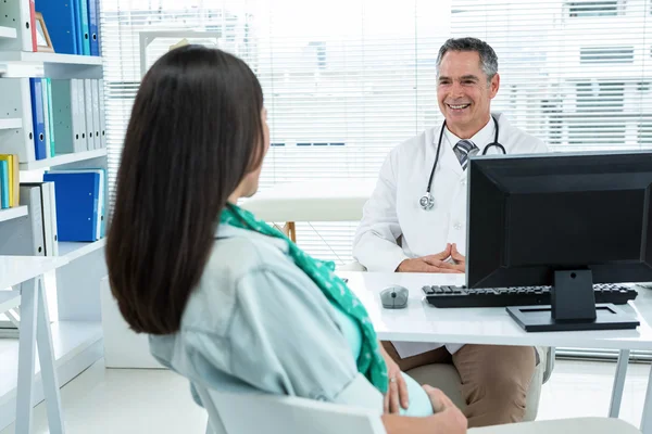Arzt interagiert mit schwangerer Frau in Klinik — Stockfoto