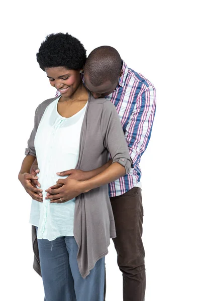 Pregnant couple smiling and embracing — Stock Photo, Image