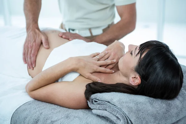 Pregnant woman receiving a stomach massage — Stock Photo, Image