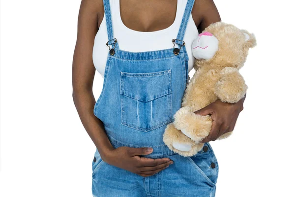 Pregnant woman holding a teddy bear — Stock Photo, Image