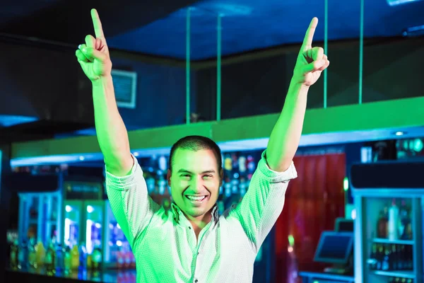 Happy man dancing in front of bar counter — Stock Photo, Image