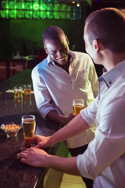 Två män har öl på bar — Stockfoto