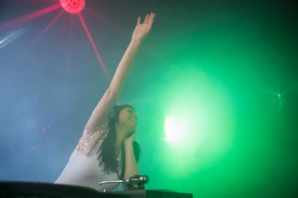 Kvinnliga Dj vifta handen medan du spelar musik — Stockfoto