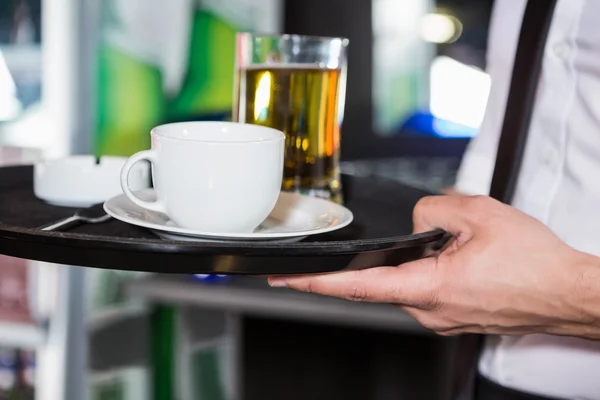 Waiter serving whiskey and a cup of coffee — Stock Photo, Image