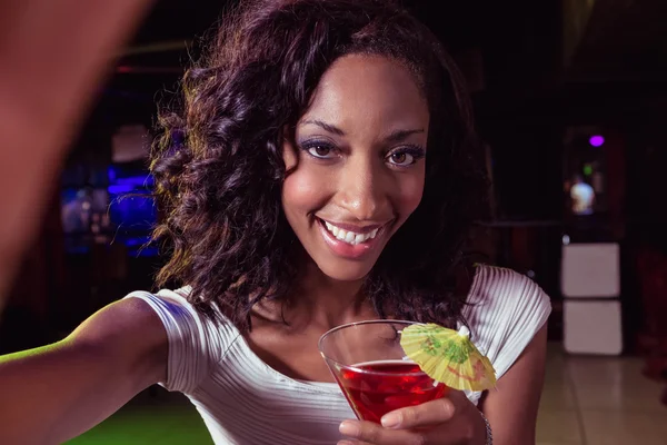 Portrait of young woman having a cocktail Royalty Free Stock Images