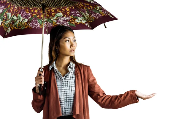 Businesswoman with an umbrella feeling the rain — Stock Photo, Image