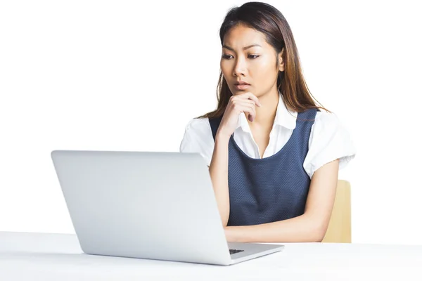 Mujer de negocios dudosa usando un ordenador portátil —  Fotos de Stock