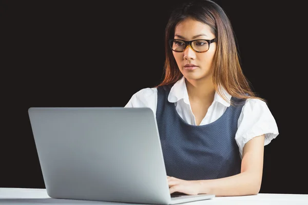 Serious businesswoman using laptop — Stock Photo, Image