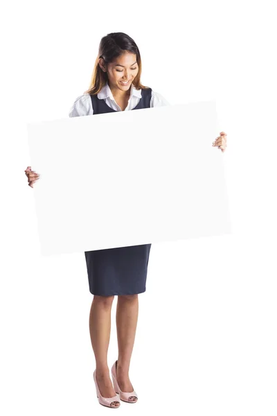 Smiling businesswoman holding a white poster — Stock Photo, Image