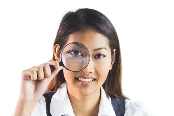 Businesswoman looking through magnifying glass Royalty Free Stock Images