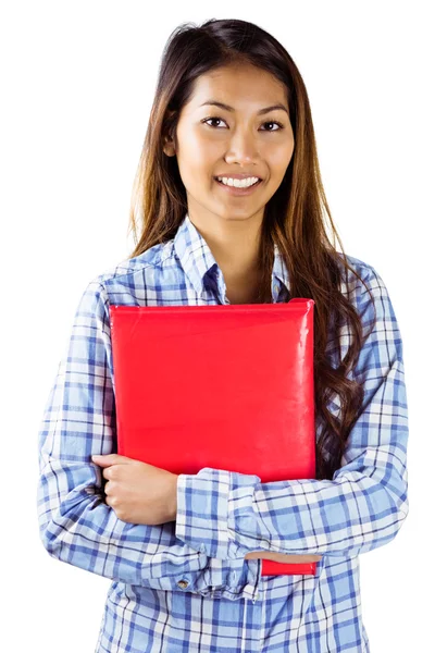 Smiling asian woman holding red book — Stock Photo, Image