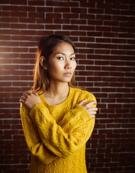 Serious asian woman with hands on shoulders — Stock Photo, Image