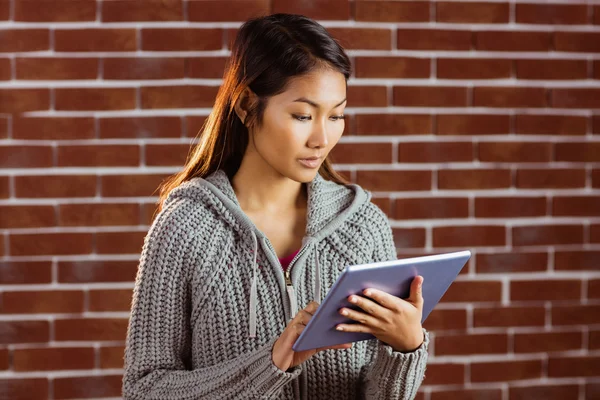 Fokuserad asiatisk kvinna använder tablet — Stockfoto