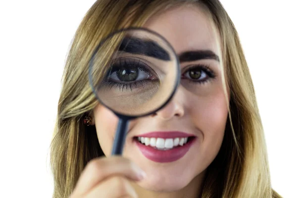 Smiling woman using magnifying glass — Stock Photo, Image