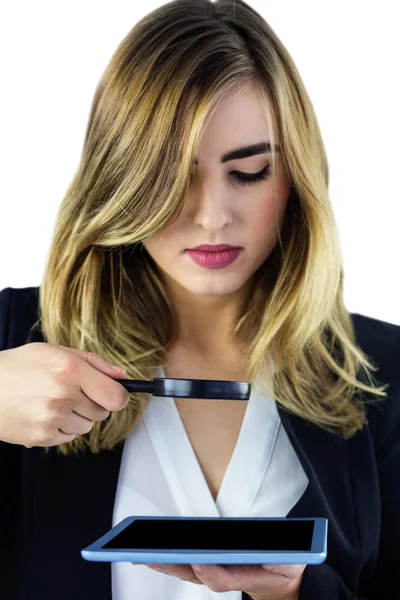 Woman using magnifying glass — Stock Photo, Image