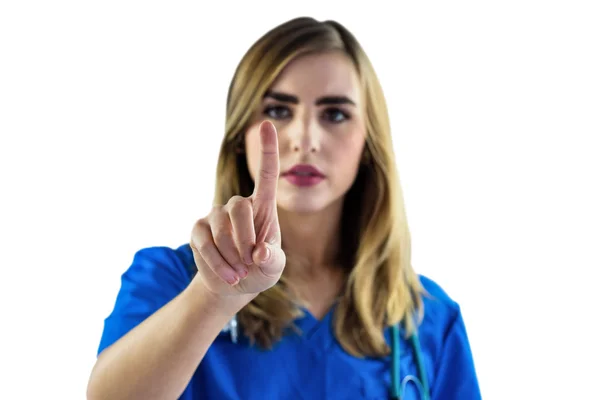 Verpleegkundige met haar vinger te wijzen — Stockfoto