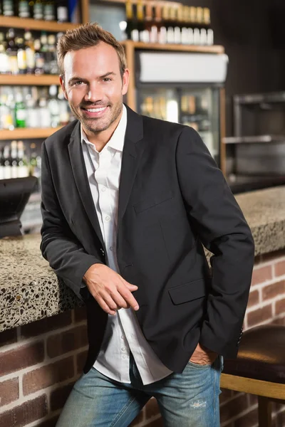 Handsome man leaning his elbow on the counter — Stock Photo, Image