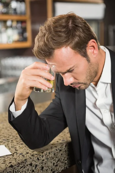 Tired man having a whiskey — Stock Photo, Image