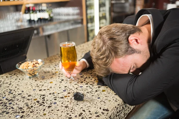 Tired man having a beer — Stock Photo, Image