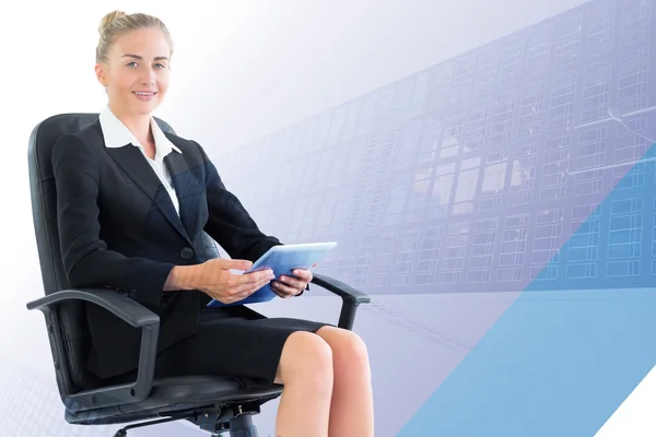 Composite image of businesswoman sitting on swivel chair with ta — Stock Photo, Image