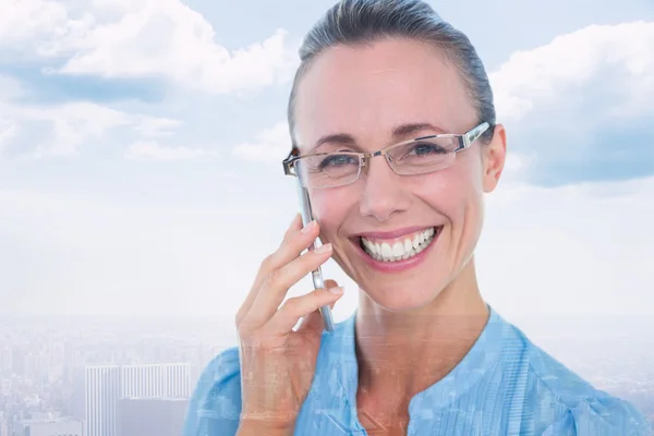 Composite image of smiling businesswoman having a phone call — Stock Photo, Image